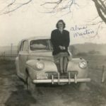 Alma Martin sitting on car