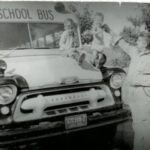 L Paul Martin with kids and old bus
