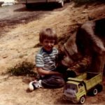 Travis Martin with toy truck and dog